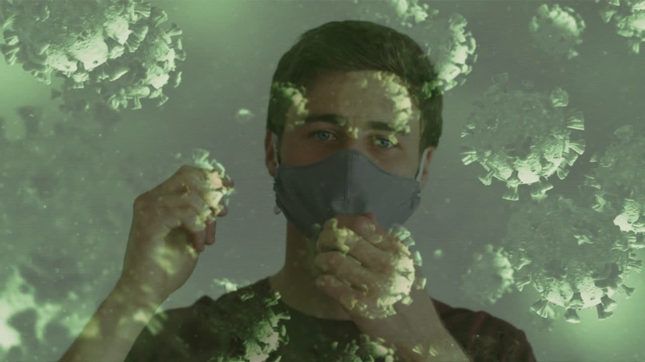 Adult male checking gray health mask lifting loops fitting while green particles moving over face