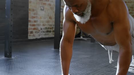 Senior-man-doing-push-ups-with-dumbbells-4k