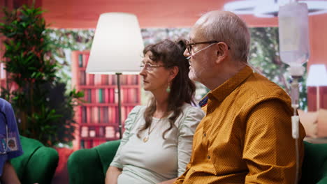 Elderly-man-with-oxygen-tube-and-IV-drip-bag-discussing-with-the-nurse