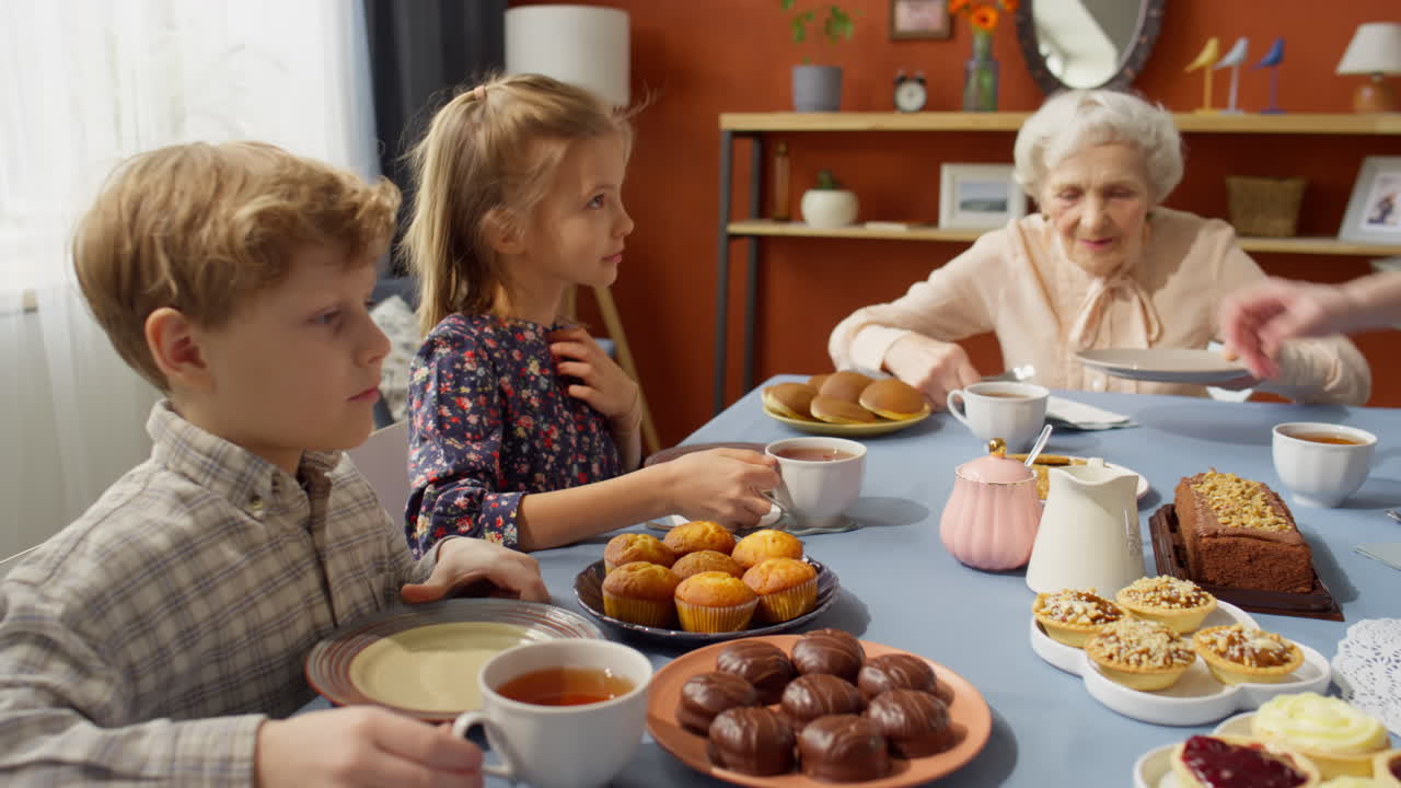 Woman Giving Plates to Family Members on Grandma Birthday Dinner