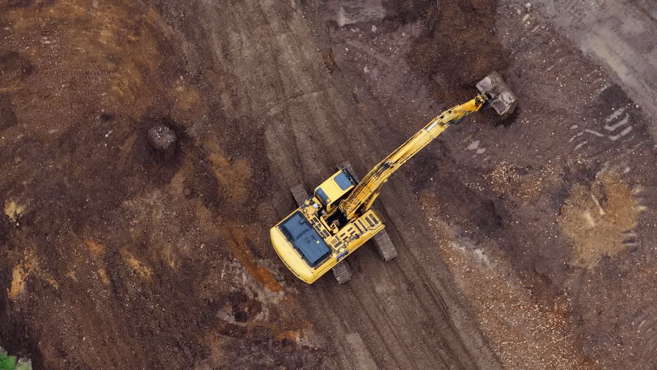 Aerial view of excavator digging dirt