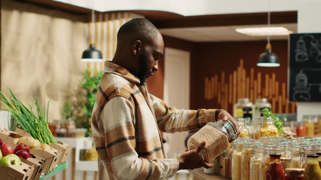 Client examining organic bulk products stored in reusable jars
