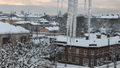 Water-dropping-from-icicles-in-winter-urban-landscape-of-Riga,-Latvia