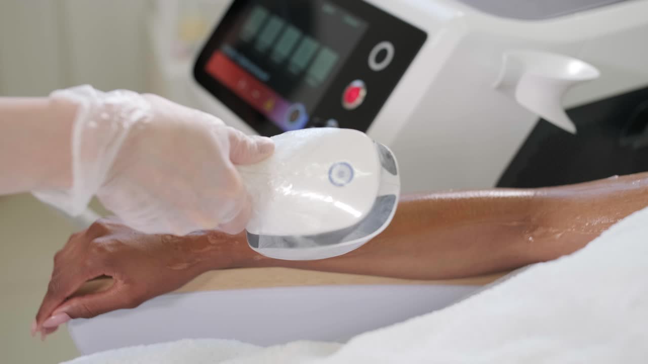 Hair removal cosmetology procedure from a therapist at cosmetic beauty spa clinic. Laser epilation and cosmetology.