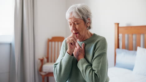 elderly woman coughing in her bedroom