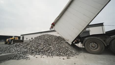 a truck dumps rubble onto a construction site. clearing site