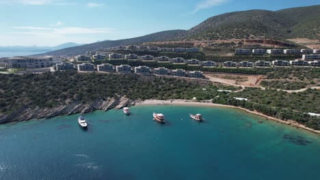 Drone of boats parked in shallow crystal blue waters on the Turkish Riviera in Bodrum