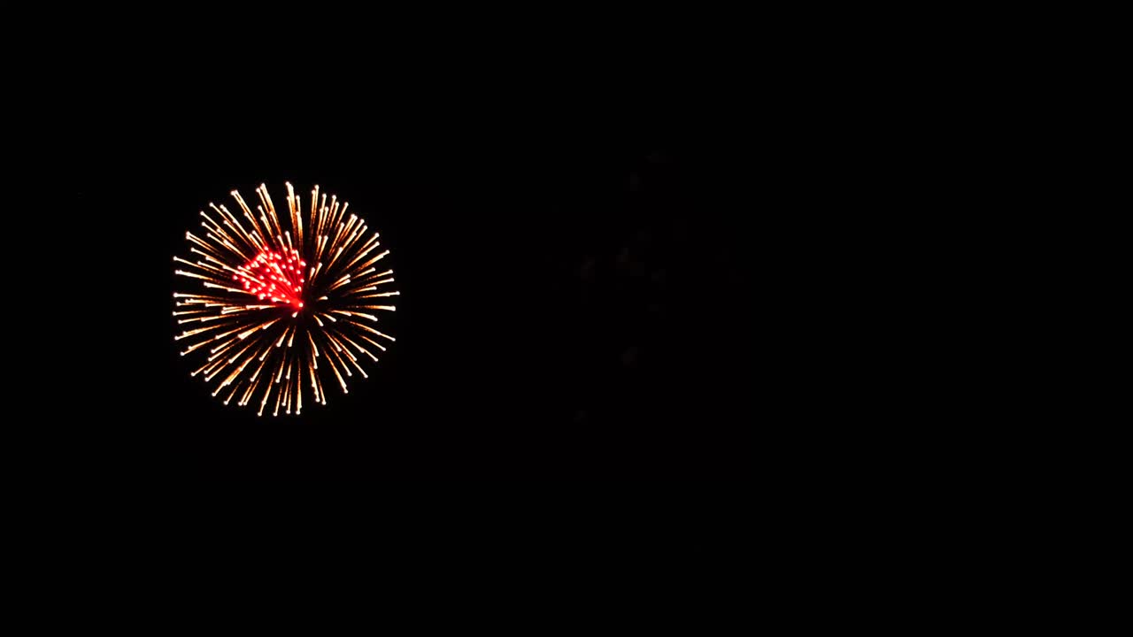 large colorful cluster aerial fireworks on July 4th with mini sparkling explosions