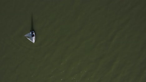 orbital shot of a sail boat with lake, from the air