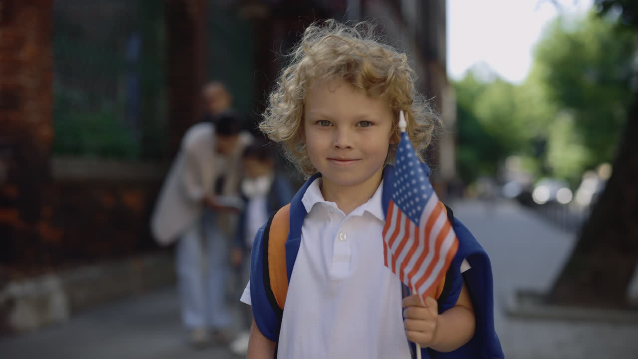 Young Boy Holding American Flag