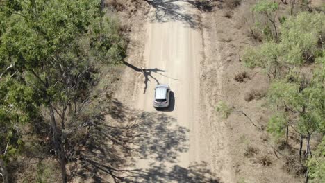 isolated car driving on rural road at st lawrence, clairview in australia