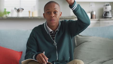 video of happy african american boy having online lessons at home