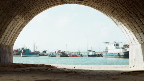 running, fitness and man in tunnel by harbor