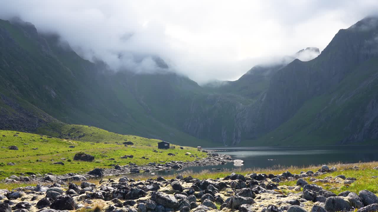 Beautiful lake surrounded by mountains on a sunny day in Eggum, Lofoten, Norway