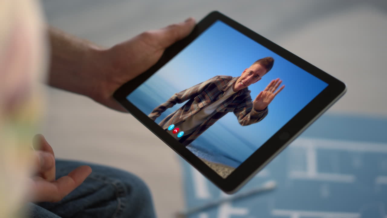 Video call on a tablet with a man on a beach