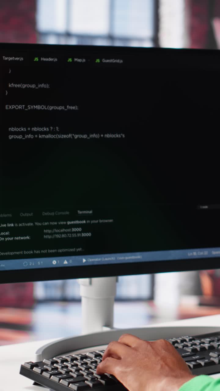 Vertical Video Male programmer types code on computer and running script