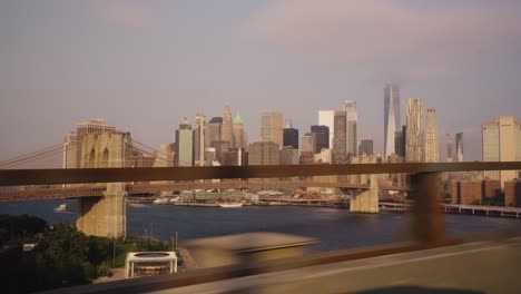pov shot of window train on bridge with beautiful skyline of new york in background
