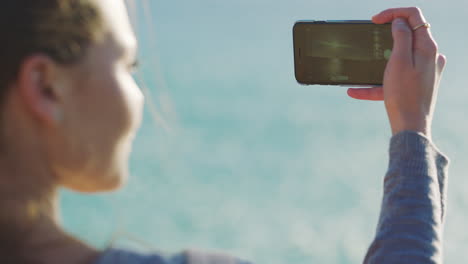 Woman,-beach-and-phone-for-sunset-photography