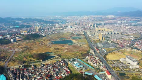 Aerial view of Chizhou City in Anhui Province, China, showcasing expansive urban development with residential buildings, roads, and open land. Highlights ongoing growth and construction in the city.