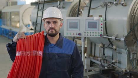 portrait of plant worker with hdpe pipes