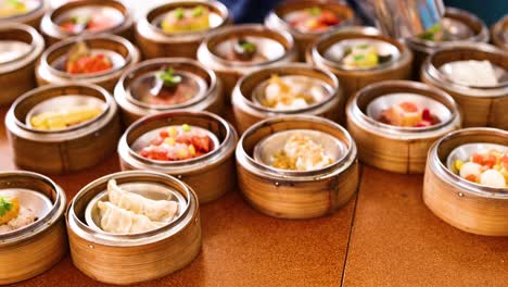 a vibrant display of assorted dim sum in bamboo steamers on a wooden table, captured in warm lighting at a phuket eatery