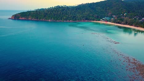 4k-Aerial-Drone-Push-Forward-Shot-of-Salad-Beach-on-Koh-Phangan-in-Thailand-with-Fishing-Boats,-Teal-Water,-Coral,-and-Green-Jungles