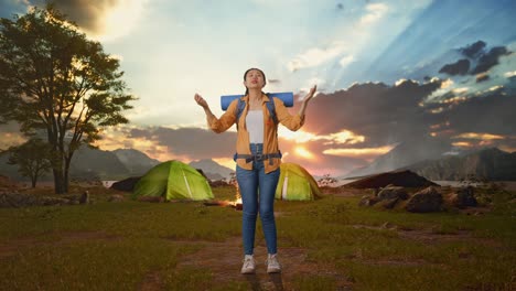 Woman enjoying a peaceful camping sunset