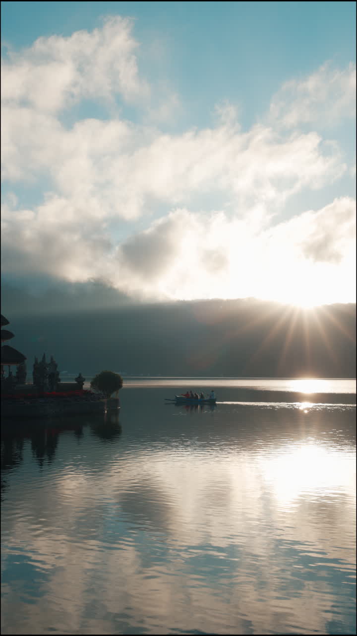 Sunburst over a Serene Lake with a Boat