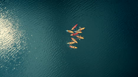 Aerial-footage-of-9-kayaks-floating-on-in-the-water