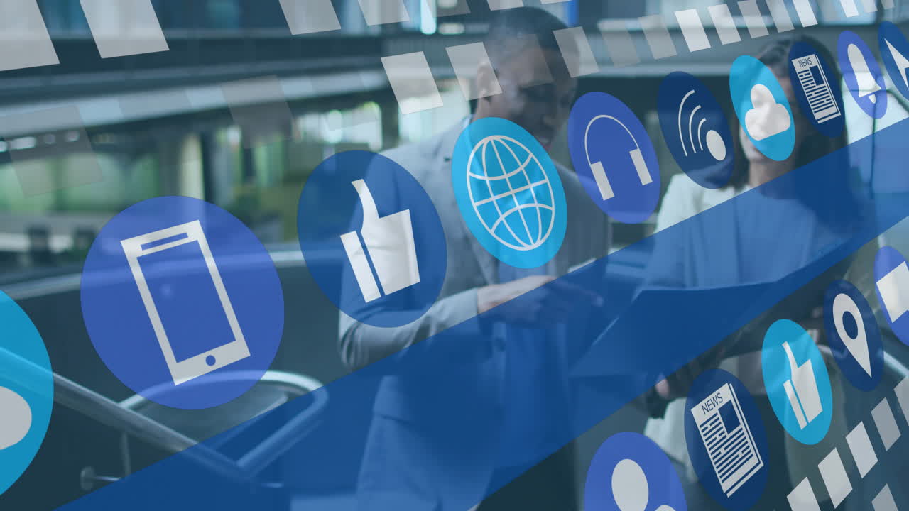 Colleagues reviewing tablet in business lobby, showing floating smartphone cloud wireless icons