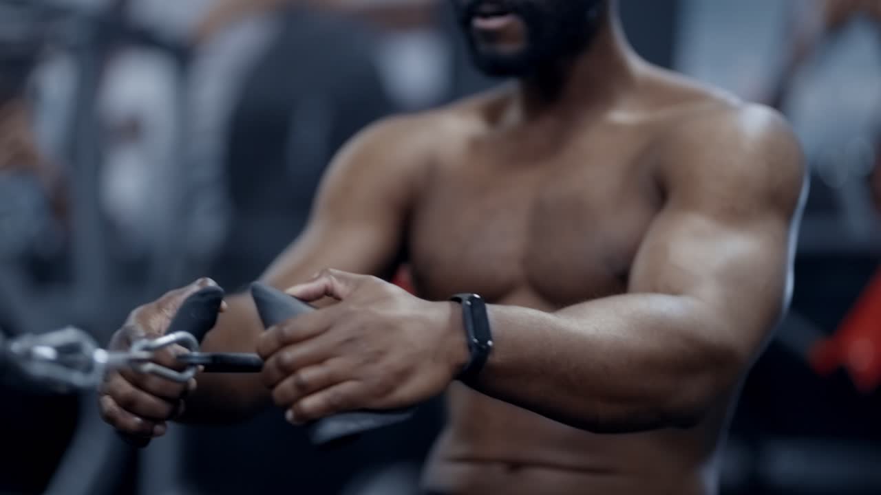 Athletic African American man performs seated cable rows