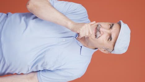 Vertical-video-of-Thoughtful-old-man-towards-camera-comes-up-with-an-idea.