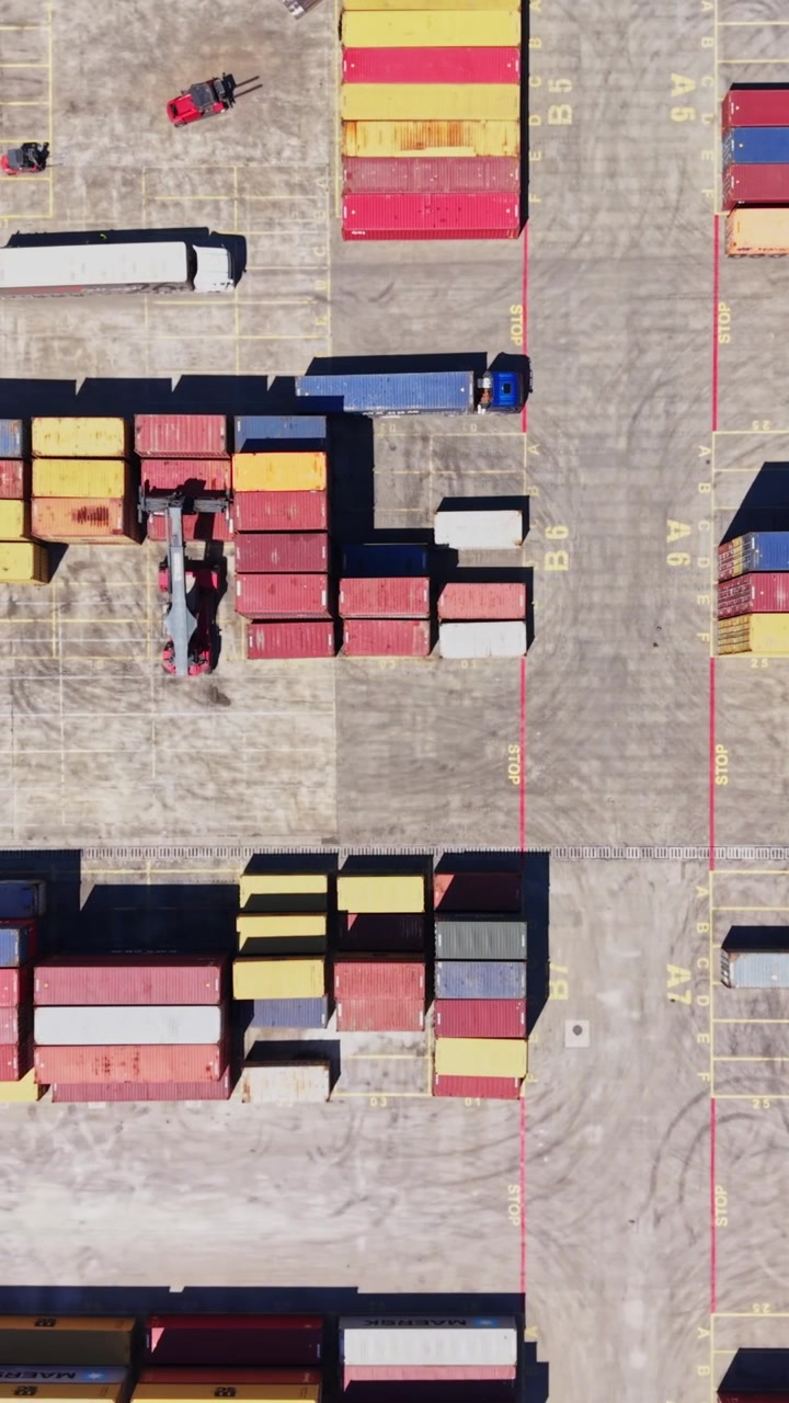 Cargo containers arranged in a shipping yard during daytime hours