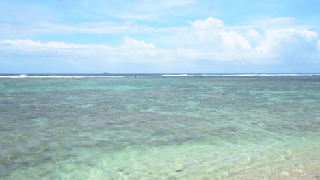 Turquoise,-transparent-and-crystalline-ocean-side-view-under-blue-sky