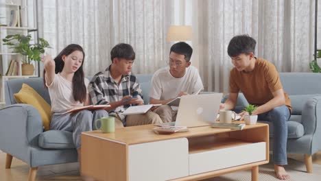 asian teen group studying at home. group with a laptop and books in conflict arguing and trying to blame each other