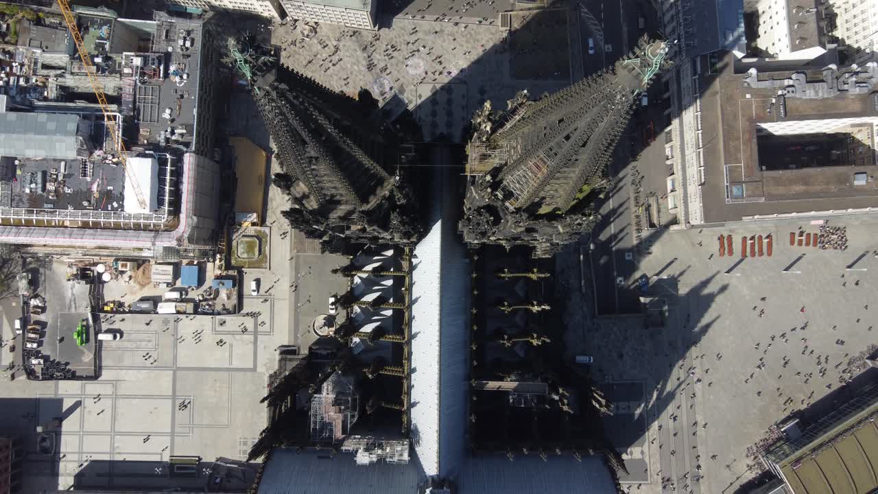 Aerial bird's eye above towering twin spires of Cologne cathedral dome