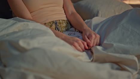 carefree lady relaxing bed at weekend evening close up. woman sitting bedroom