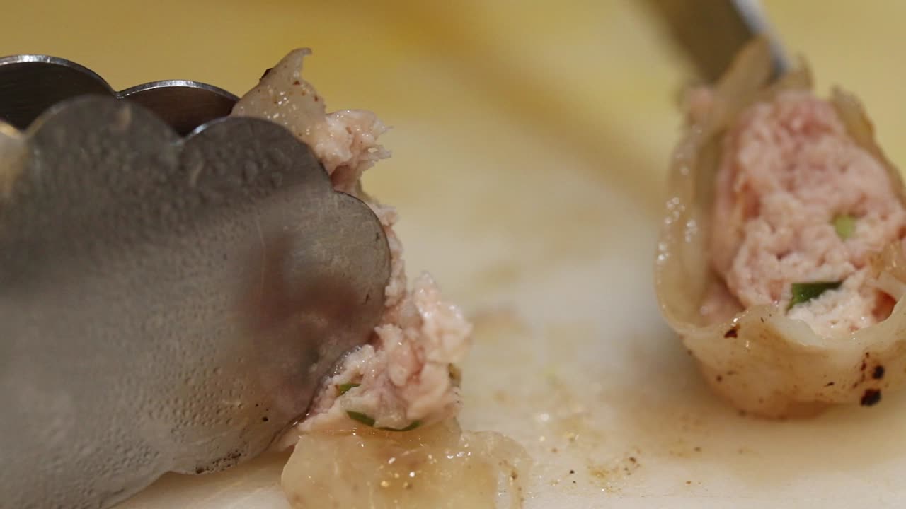 Pulling Apart Cooked Meat on a Cutting Board
