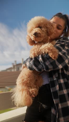 woman holding a poodle