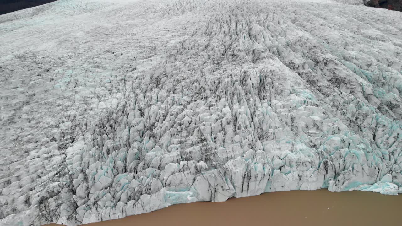 Aerial, drone shot, overlooking ice masses, at the Jokulsarlon glacier, on a foggy, overcast day, in Iceland