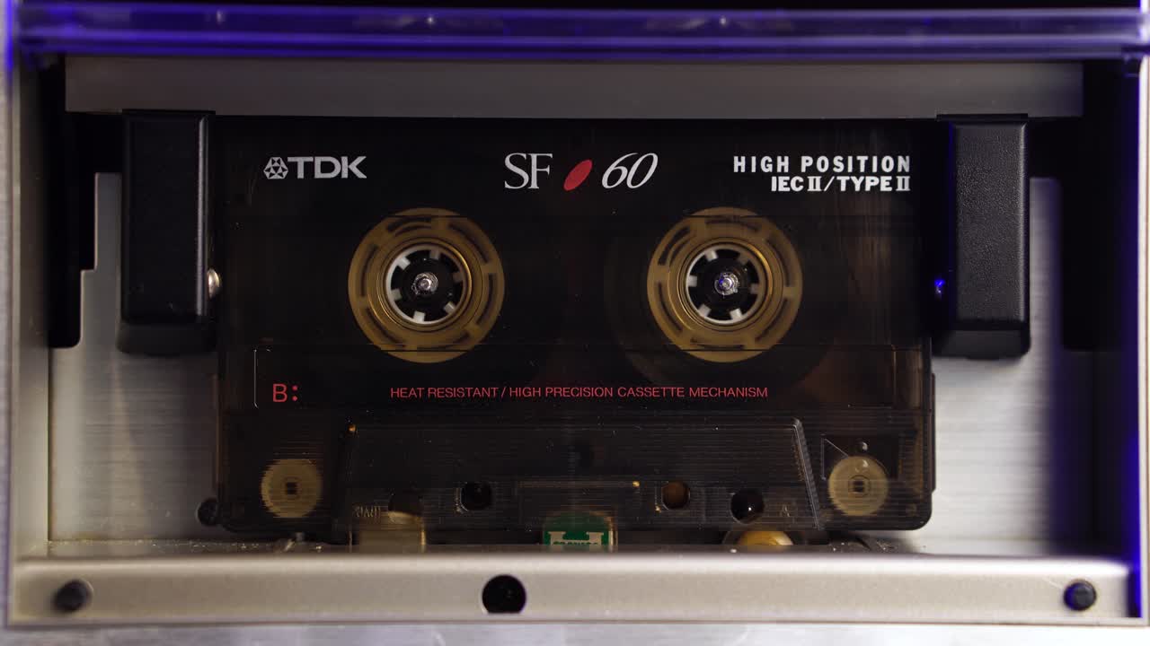 Vintage Audio Cassette Tape Rolling During Recording or Playback, Close Up
