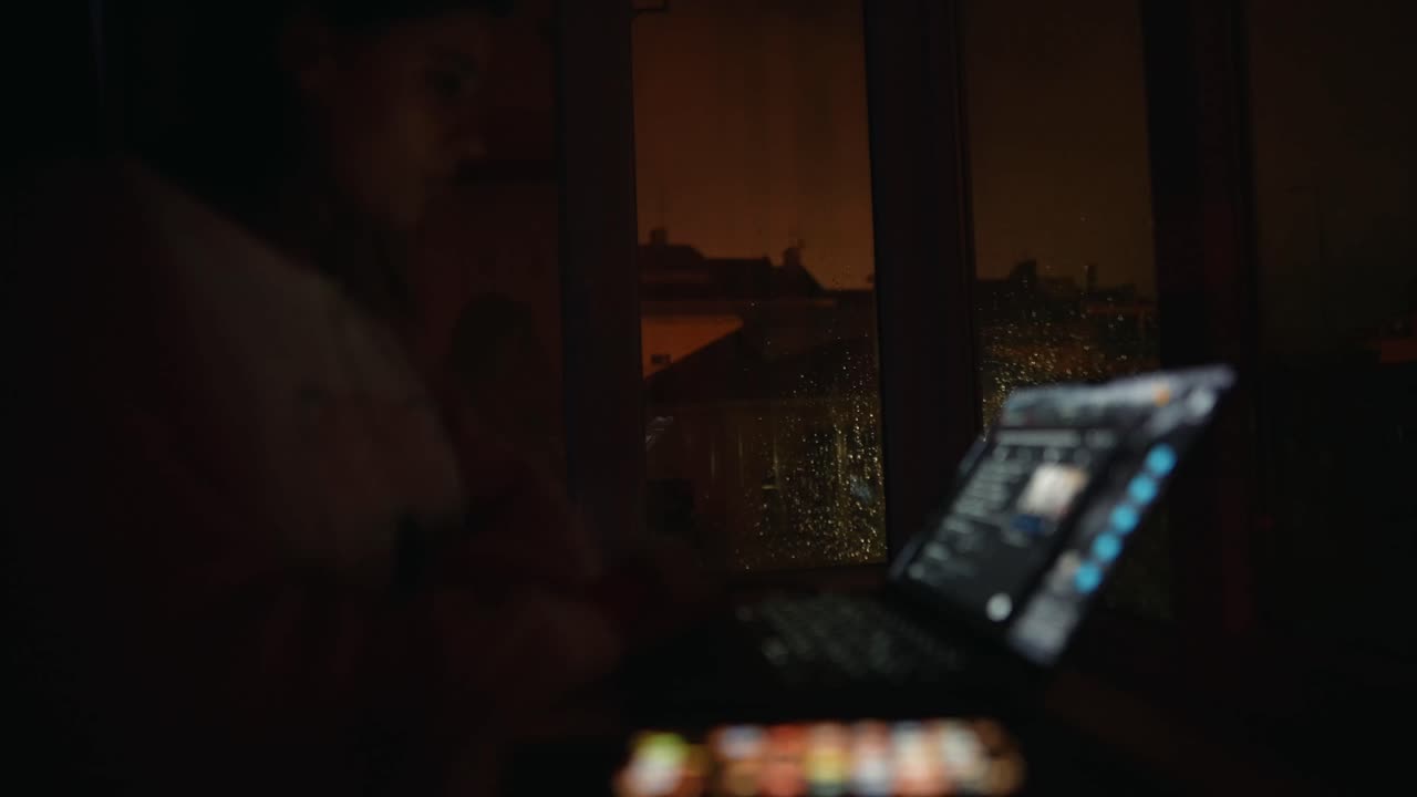 Laptop by a Rainy Window at Night