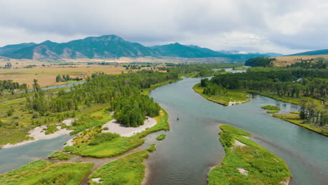 aerial view of a river winding through a mountain valley