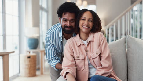 happy couple laughing together in their living room