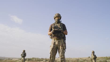 men in uniform controlling field area and collecting data