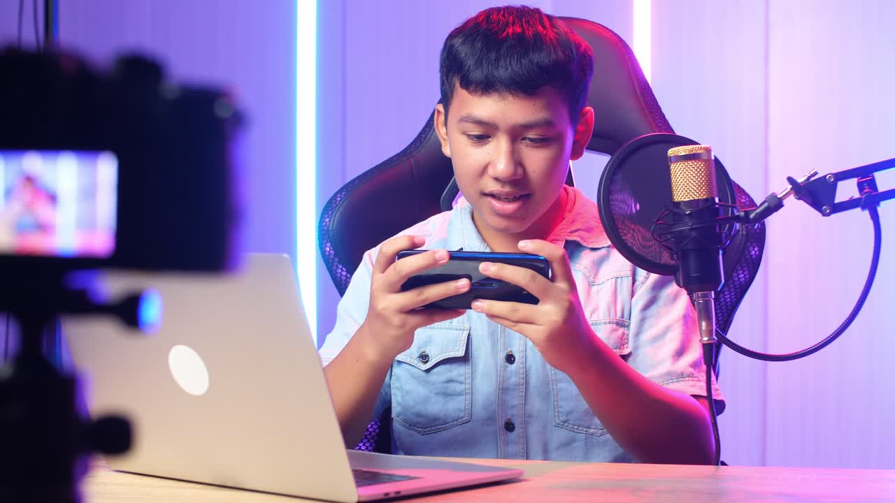 Asian Kid Boy Playing Video Game With Mobile Phone Then Celebrating While Live Stream