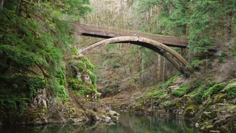 Focused-shot-of-arch-bridge-spanning-Lewis-River-at-Moulton-Falls,-Static