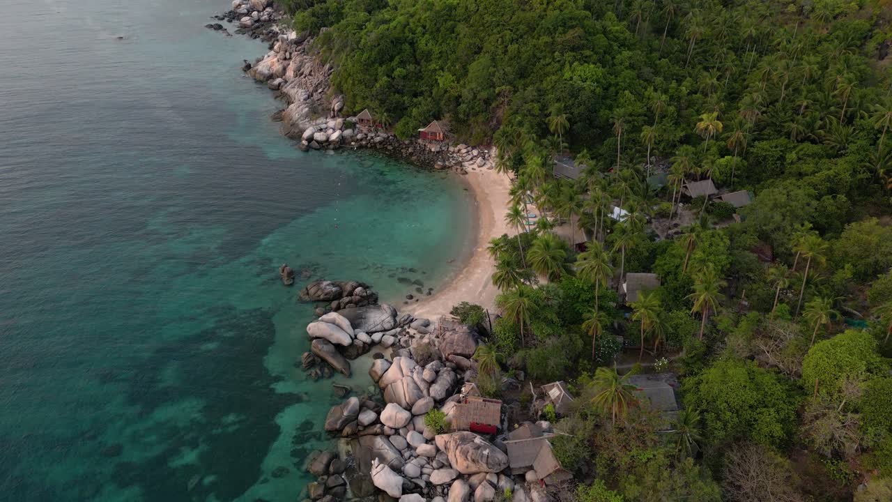 Drone flight over stunning tropical bay with jungle backdrop