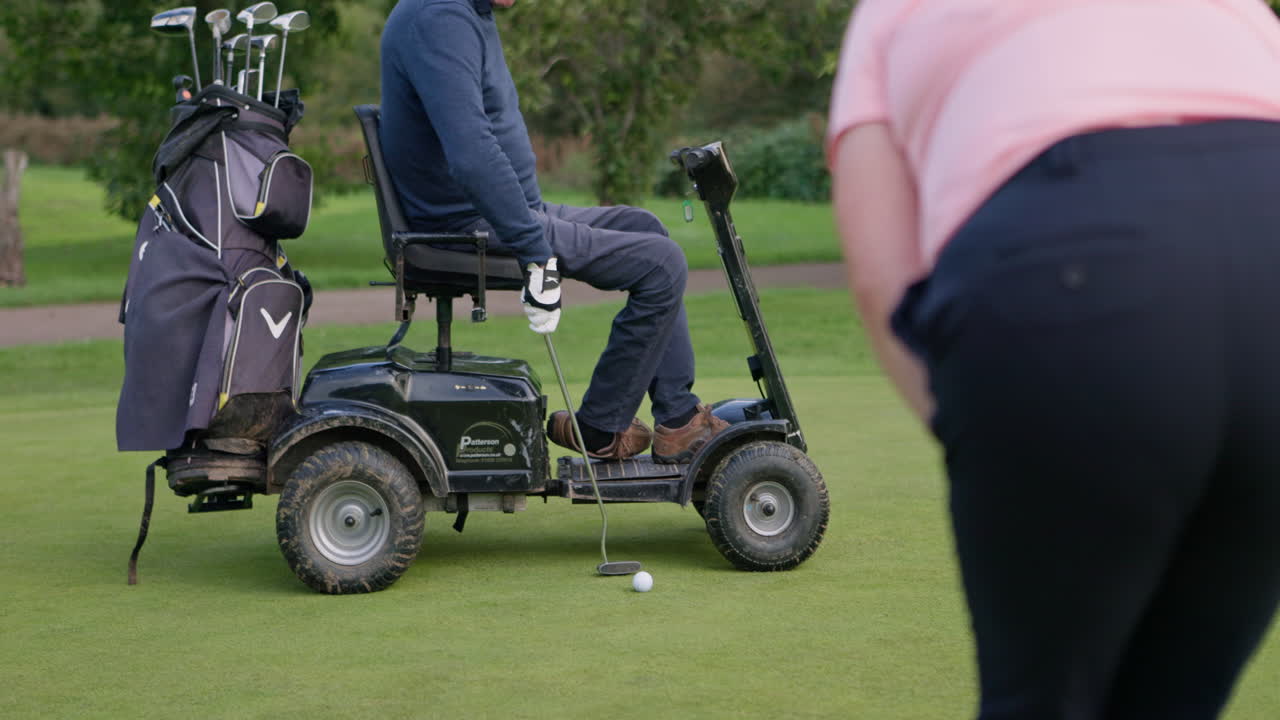 People playing golf with a mobility scooter
