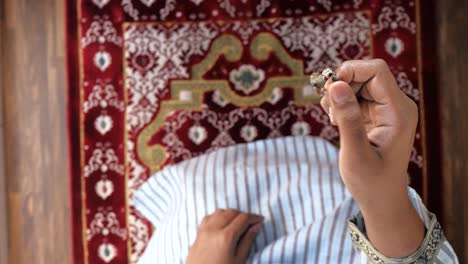 muslim praying on a prayer mat